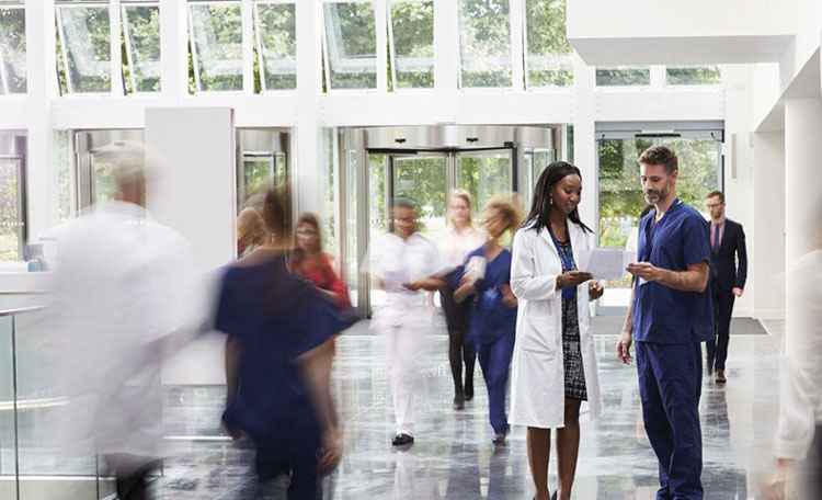 doctors reviewing document in hospital lobby (image)
