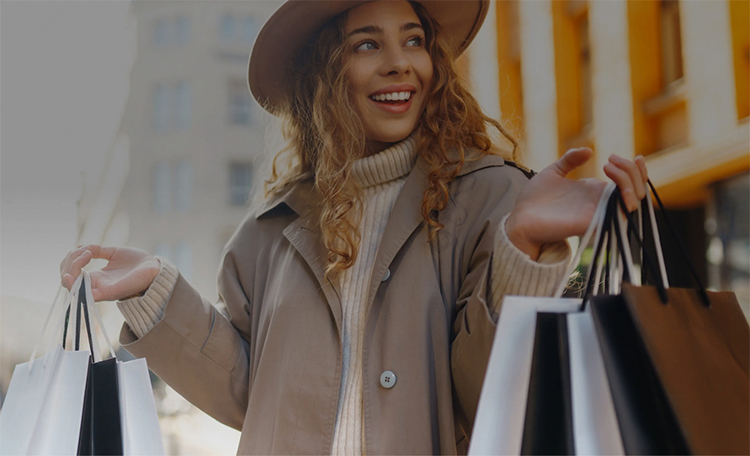 Woman holding shopping bags in retail setting (image)