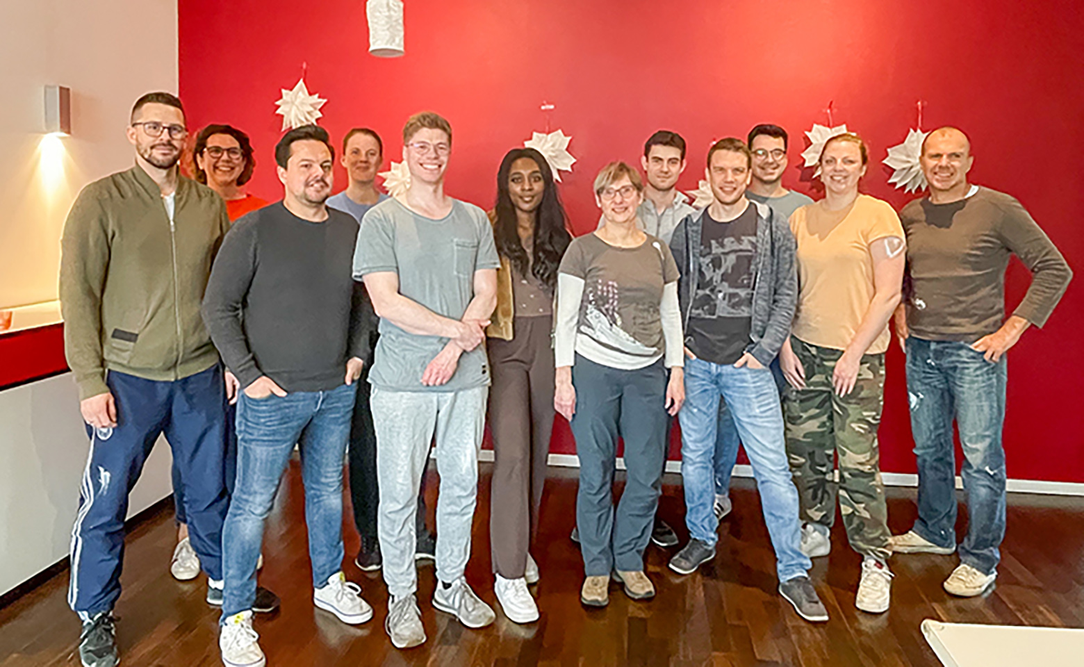 Group of people in front of  red wall