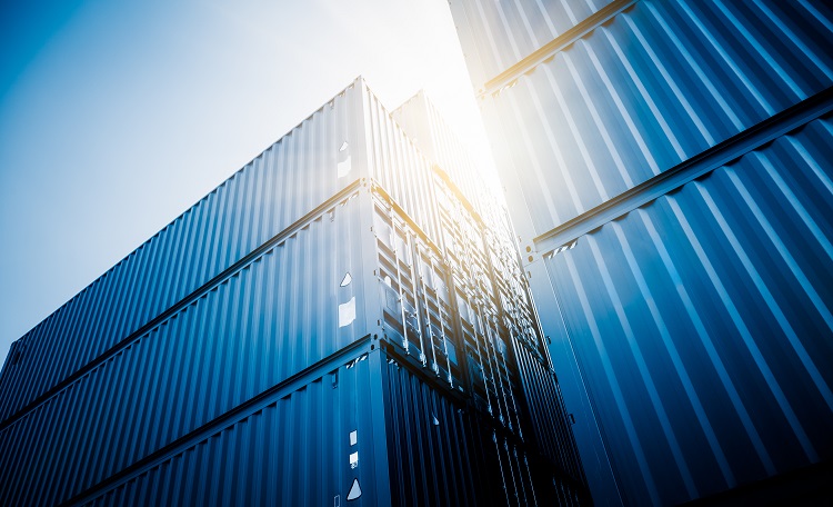 blue containers looking upwards, sun between