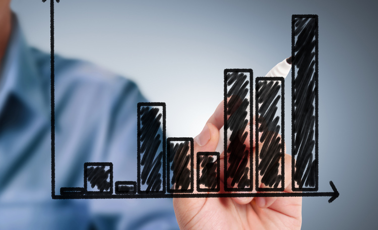 person drawing a chart in marker on glass