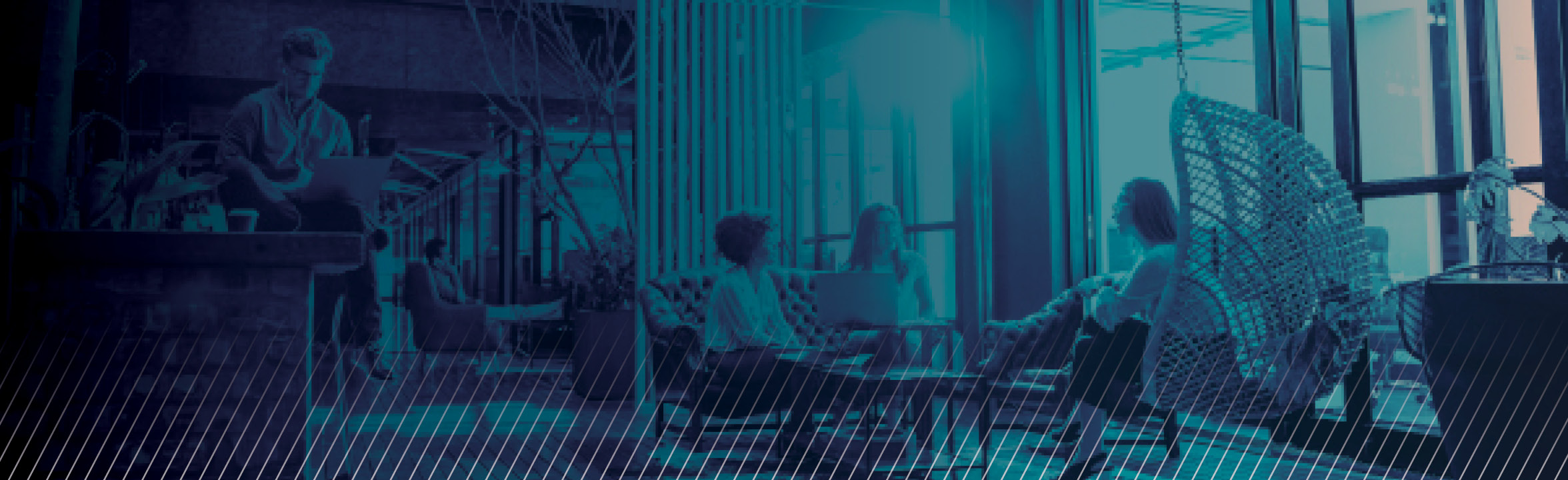people sitting in open office area by large window in blue duotone