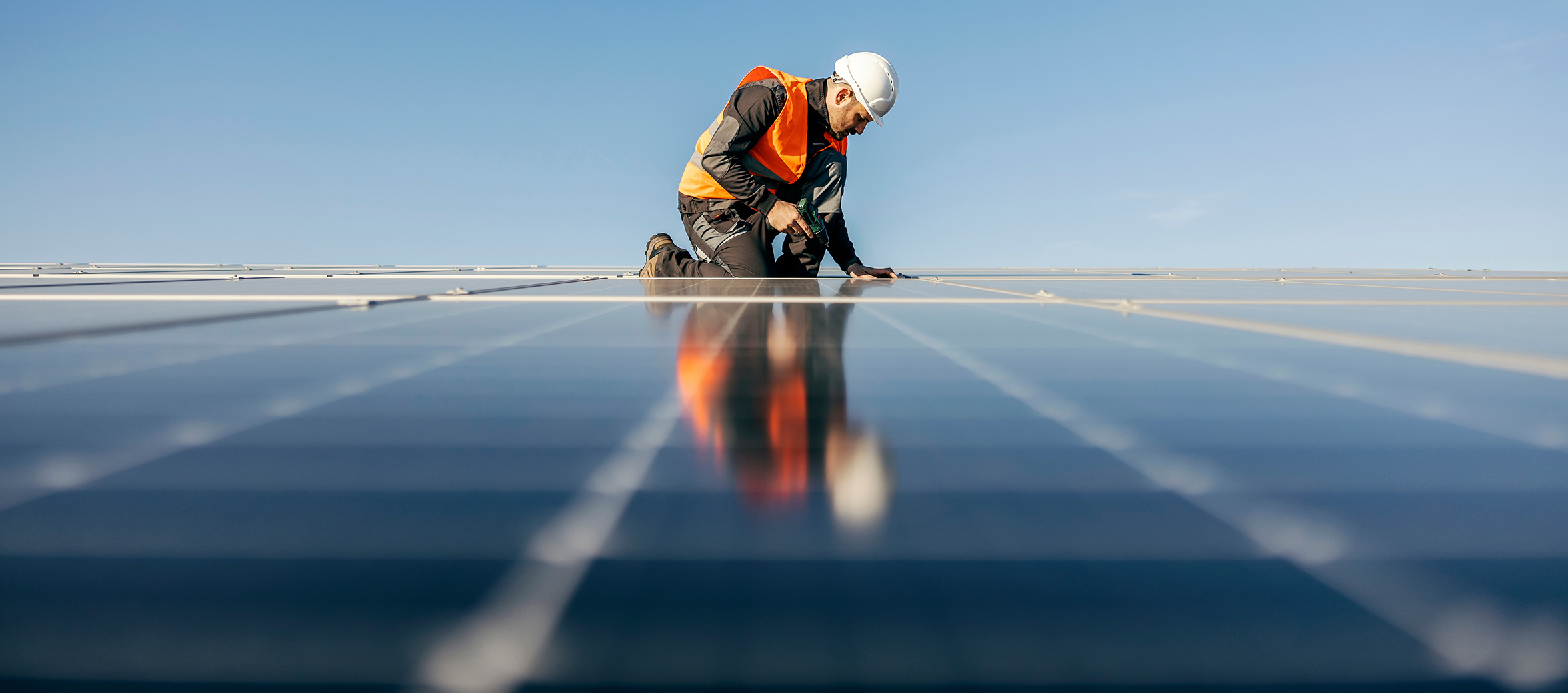 man working on solar panels